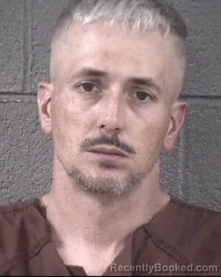 Mugshot of JUSTIN CARL COXE booked in Buncombe County, North Carolina on March 27, 2026