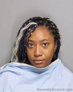 Mugshot of KIARRA ADRIANNA-RESHALE MOSS booked in Champaign County, Illinois on May 6, 2026