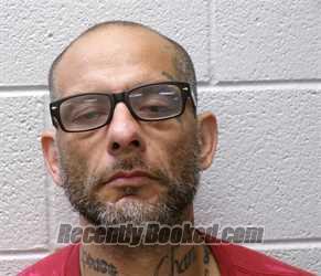 Mugshot of JOHN CARLOS FLORES booked in Henderson County, North Carolina on May 14, 2026