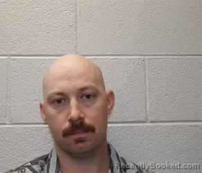 Mugshot of JUSTIN CODY MOORE booked in Henderson County, North Carolina on April 30, 2026