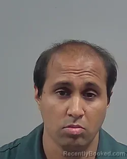 Mugshot of Mikhail Kishor Patel booked in Escambia County, Florida on October 24, 2026