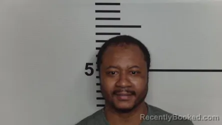Mugshot of DEZMON M MOORE booked in Jefferson County, Kentucky on May 20, 2026