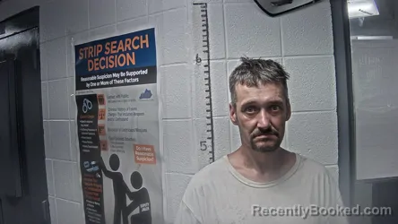 Mugshot of TRAVIS RAY TACKETT booked in Letcher County, Kentucky on July 7, 2026