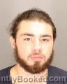 Mugshot of John Edward Alaniz booked in Oakland County, Michigan on August 24, 2026