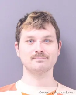 Mugshot of RYAN C HUGHES