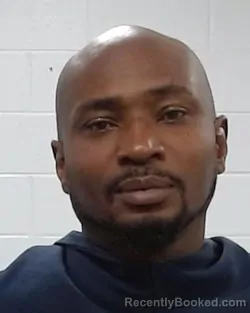 Mugshot of Ken Okobla Emuakpor booked in Collin County, Texas on March 31, 2026