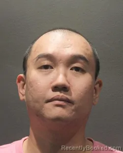 Mugshot of TRAN D.K. CAO booked in Arlington County, Virginia on May 9, 2026