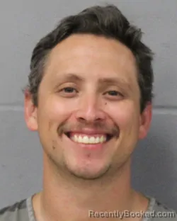 Mugshot of Justin Santos booked in Travis County, Texas on July 26, 2026
