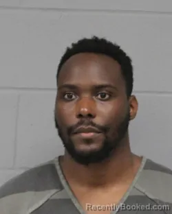 Mugshot of Obiora Okoye booked in Travis County, Texas on August 9, 2026