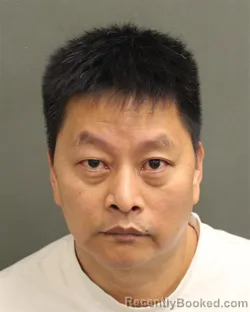 Mugshot of XIN ZHI LI booked in Orange County, Florida on April 28, 2026