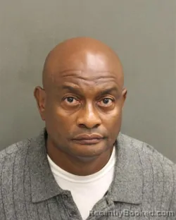 Mugshot of HUGUES ENARLD PIERRE booked in Orange County, Florida on May 11, 2026