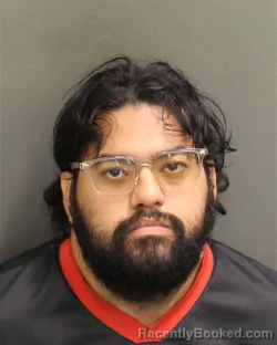 Mugshot of Alvid Enrique Nieves booked in Orange County, Florida on August 9, 2026