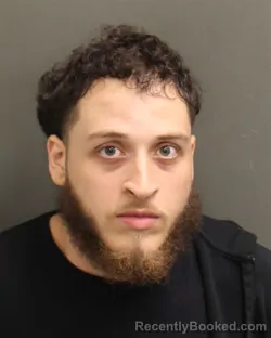 Mugshot of Oliver Enrique Ortiz booked in Orange County, Florida on August 10, 2026