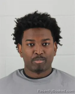 Mugshot of DAYLAN EDWARD MBURU booked in Johnson County, Kansas on March 7, 2026