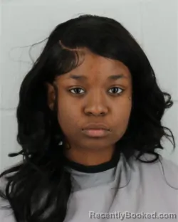 Mugshot of MICHELLE NICHODERMS MWADUMA booked in Johnson County, Kansas on April 5, 2026