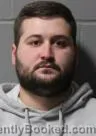 Mugshot of Logan Michael Kooi booked in Clinton County, Iowa on October 2, 2026